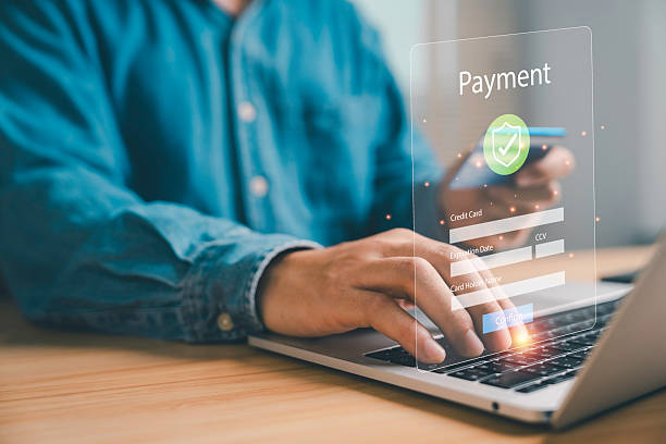 istock Secure online payment concept with digital transaction, man using laptop and smartphone entering credit card details, fintech, e-commerce, safe internet banking technology. 2234773690