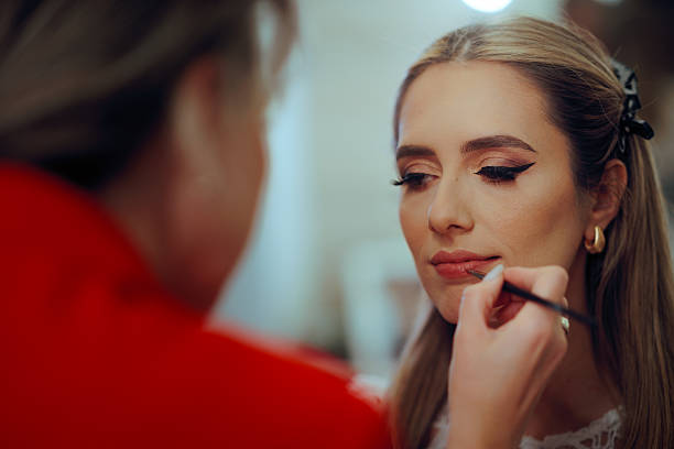 istock Professional Makeup Artist Applying Lipstick with a Lip Brush 2234777417