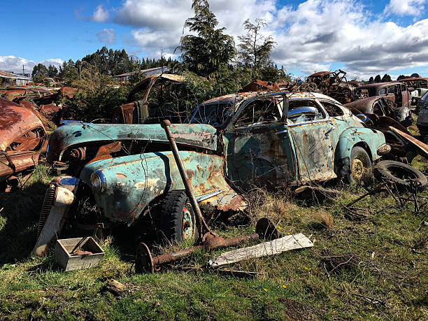 Close-up of an old wrecked car with rusted metal and peeling paint. Weathered antique vehicle showing decay, corrosion, and textured details, ideal for concepts of aging, nostalgia, or industrial grunge.