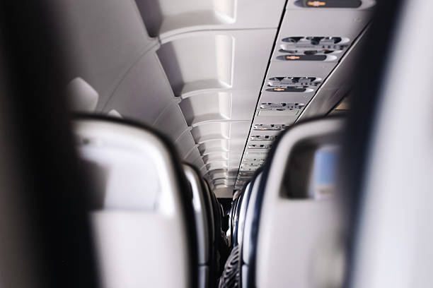 istock Airplane cabin interior view. Passenger aircraft seats. Modern travel transportation. Empty aisle perspective. 2234789436