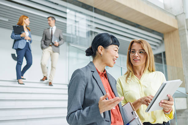 istock Businesswomen collaborating using digital tablet in modern office 2234792067