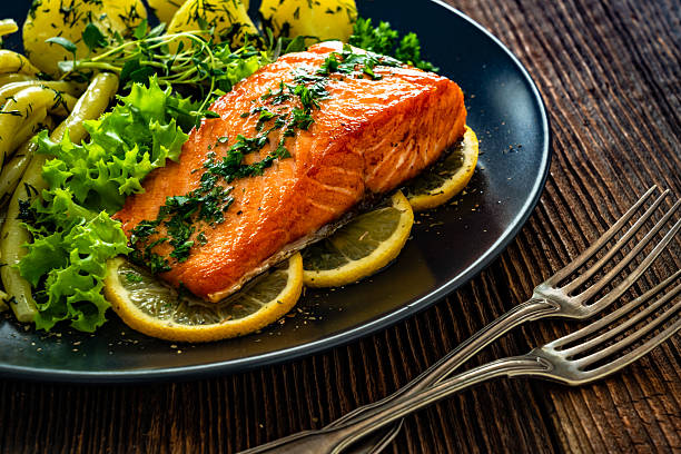 istock Seared salmon steaks with  string beans and boiled potatoes on wooden table 2234792736