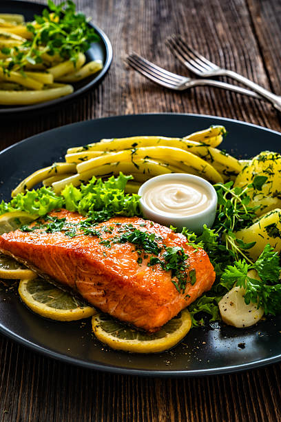 istock Seared salmon steaks with  string beans and boiled potatoes on wooden table 2234792816