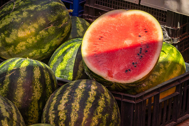 istock Sliced Watermelon Displayed at a Sunny Market Stall 2234794411