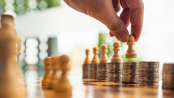 istock Chess pawn on stack of coins with hand placing piece, symbolizing financial strategy, investment planning, business decision-making, risk management, and economic game in competitive market. 2234795273