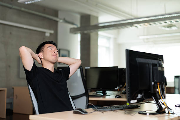Profile photo of young corporate man sit chair look screen wear shirt loft interior modern office indoors.