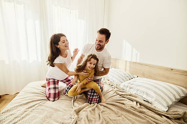 istock Cheerful family having fun during morning on a bed. 2234799505