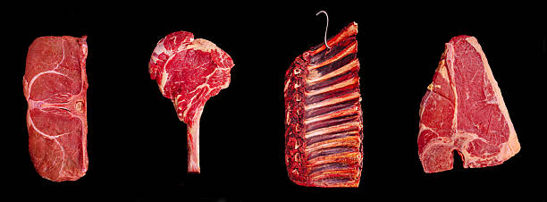 istock Different cuts of fresh red meat displayed against a black background 2234800153