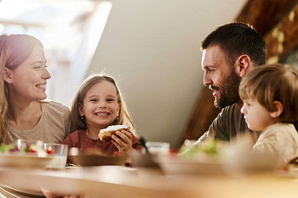 istock Young family talking during breakfast at dining table. 2234801747