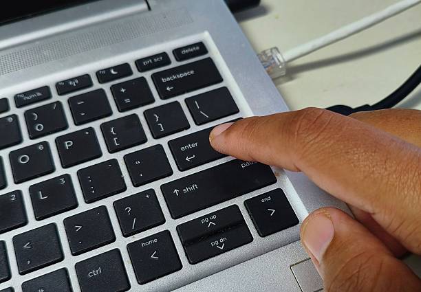 istock Pressing Enter Key on Laptop Keyboard 2234803426