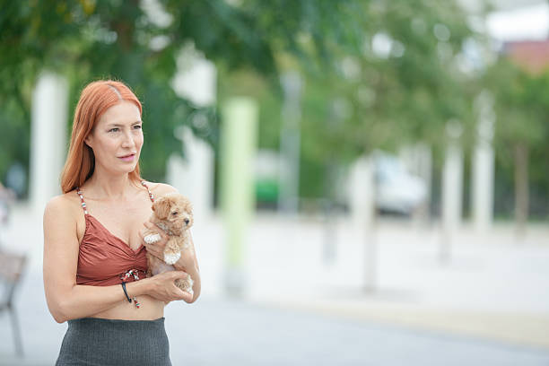 istock A woman holding a small dog 2234804461