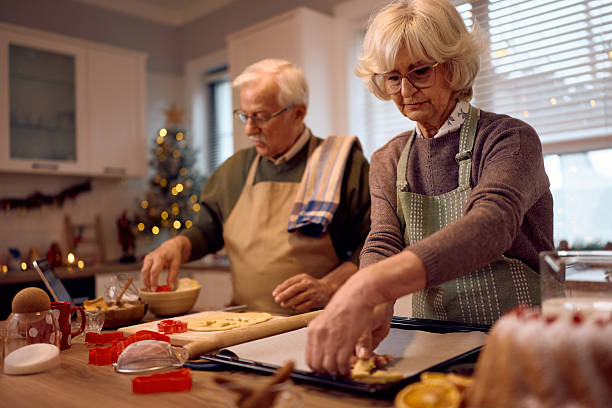 istock Senior souple cooperating while baking Christmas cookies at home. 2234805607