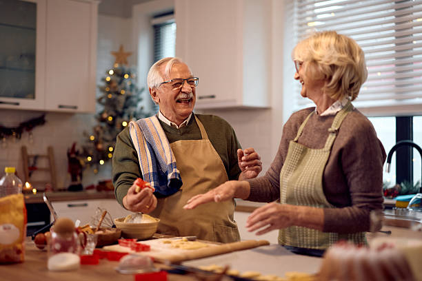 istock Cheerful senior couple having fun while making Christmas cookies in the kitchen. 2234805633