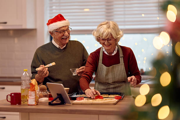 istock Happy senior couple having fun while making gingerbread cookies for Christmas. 2234805699