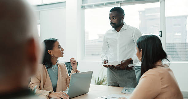istock Presentation, feedback and man in meeting, team and documents for budget report. People, financial agency and employees in office, discussion and proposal for profit growth, cooperation and planning 2234806024