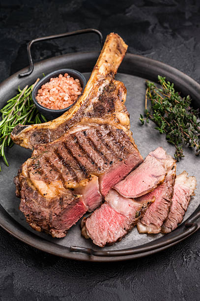istock Roasted Tomahawk beef steak, roast dry aged rib eye with bone. black background. top view 2234807934
