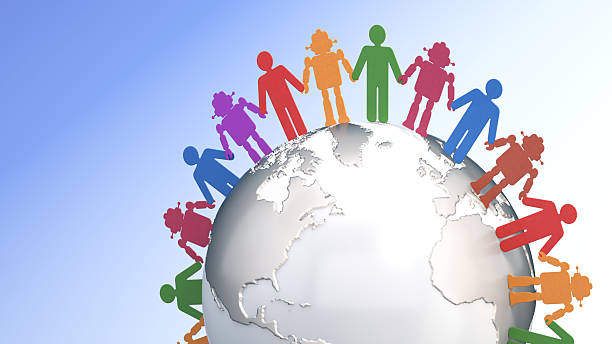 A group of colorful robot and human paper cut figures stands hand in hand around a globe, representing unity and diversity among humans and AI.