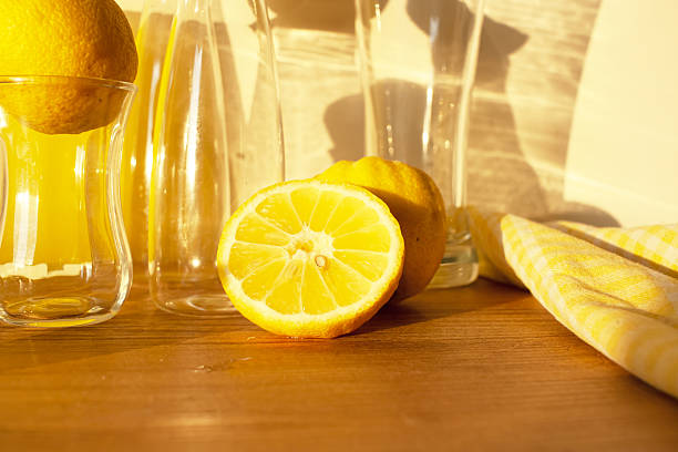 istock Lemons with lemonade, Still life with lemons, glass goblets, decanter with lemonade, glassware. background 2234808400