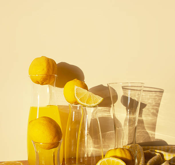 Lemons with lemonade, Still life with lemons, glass goblets, decanter with lemonade, glassware. background