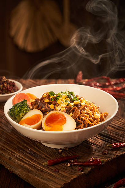 Handmade ramen and runny eggs sizzling in a bowl