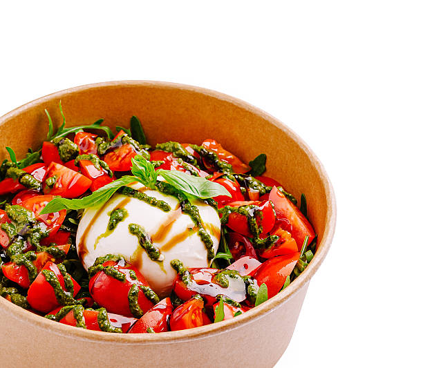 istock Fresh salad with mozzarella, tomatoes, and basil in a bowl 2234809942