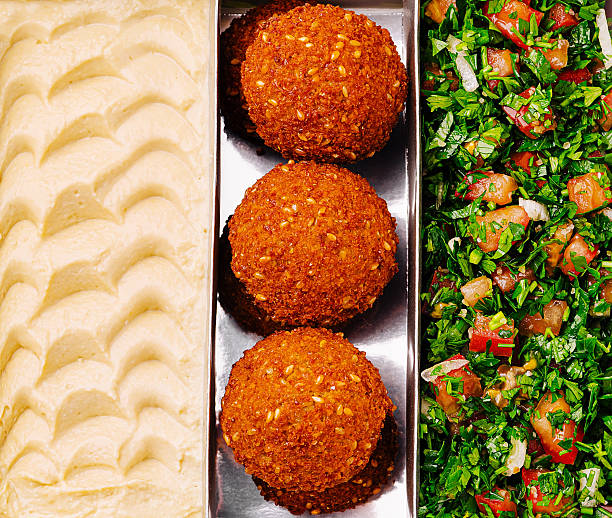 Enjoying delicious falafel, fresh salad, and creamy dip at lunchtime