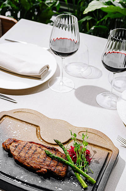 istock Delicious steak and wine served elegantly on a table setting outdoors 2234810293