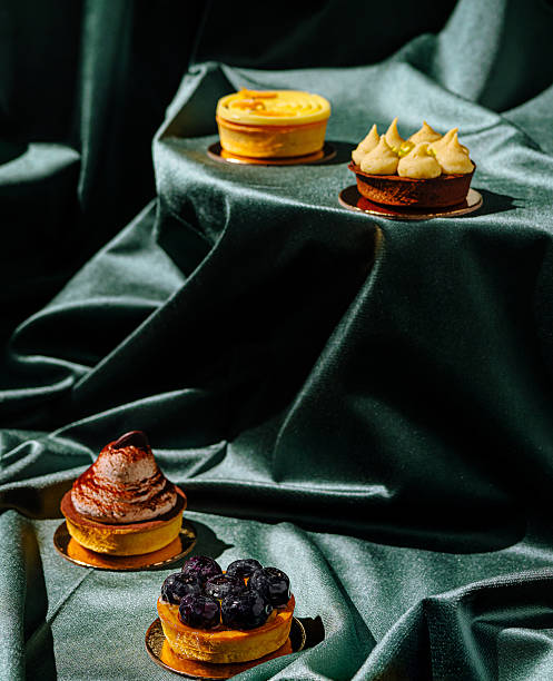 istock Colorful desserts arranged on a rich green fabric surface in a culinary display 2234810369