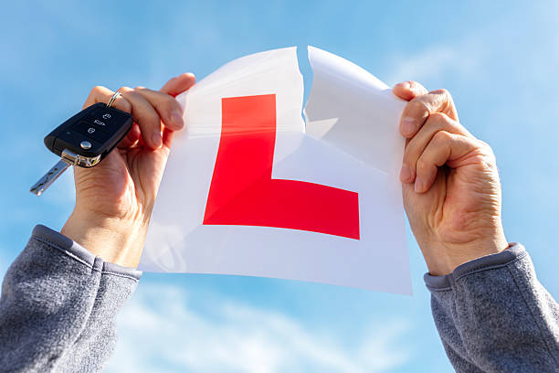 istock Tearing up L plate after passing driving test 2234812238