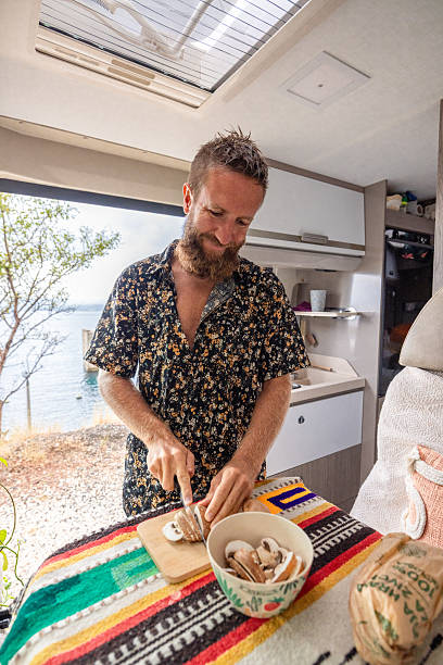 istock Man Slicing Mushrooms on Cutting Board Indoors 2234815876