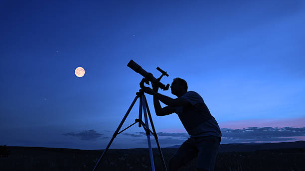 istock Amateur astronomer using telescope for watching stars, Moon, planets and other celestial objects from a field in nature. 2234815945