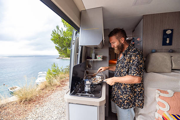 istock Man Cooking Mushrooms in Camper Van Kitchen 2234815976