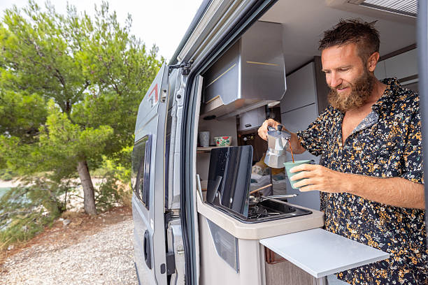 istock Man Making Coffee Inside Camper Van Outdoors 2234816536