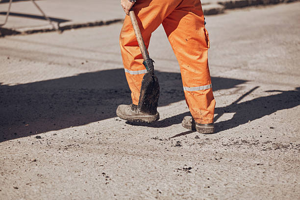 istock Construction workers working on a new asphalt layer on a public street. 2234816755