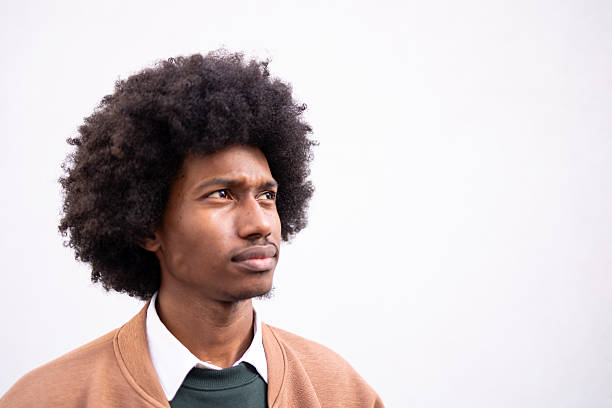 istock Contemplative young man with casual attire against a plain background 2234817640