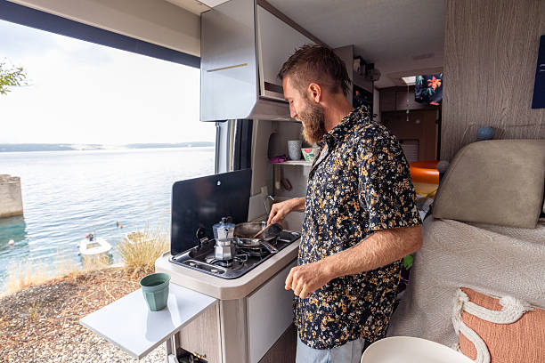 istock Man Cooking in Camper Van by Lakeside 2234817732