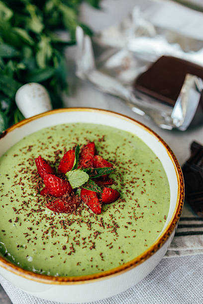 istock Ready green smoothie in a bowl with strawberries and dark chocolate 2234817842