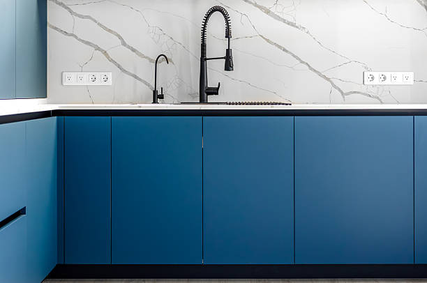 istock Blue kitchen fronts. Marble backsplash wall. Black premium faucet 2234818823