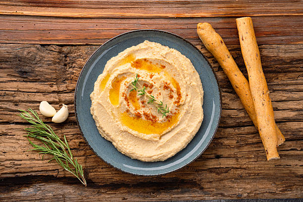 istock A traditional dish or appetizer hummus or baba ghanoush on wooden background 2234819248