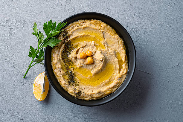 istock A traditional dish or appetizer hummus or baba ghanoush on vintage background 2234819472