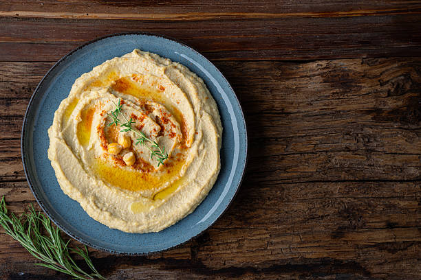 istock A traditional dish or appetizer hummus or baba ghanoush on wooden background 2234819881