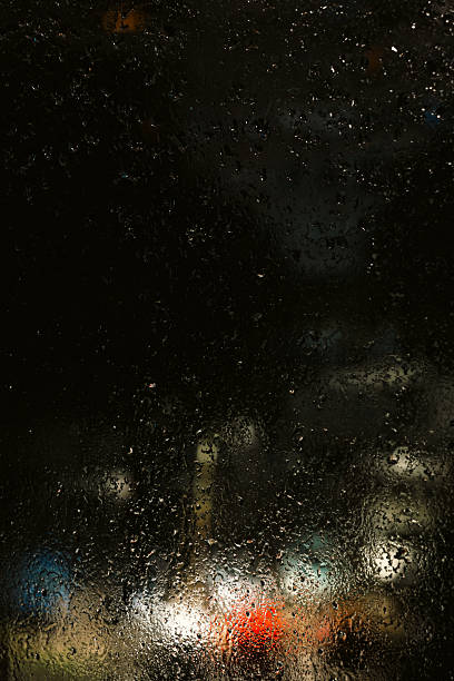 istock Rainy Night Cityscape Through Wet Window with Copy Space and Cinematic Mood. 2234820514