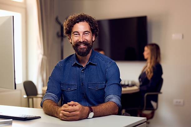istock Smiling Professional Man at Office Desk During a Meeting Discussion 2234821713