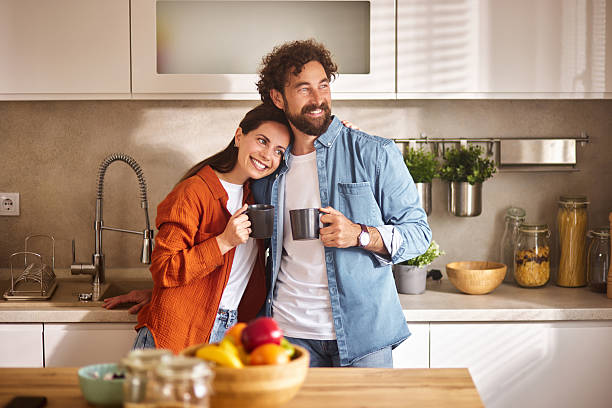 istock Happy couple enjoying morning coffee in modern kitchen 2234823260