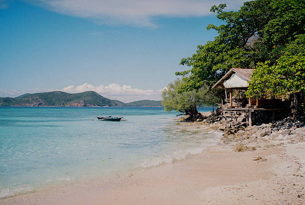 Idyllic tropical island with white sand on the Philippines. Shot on camera film during vacation with post card like aesthetic