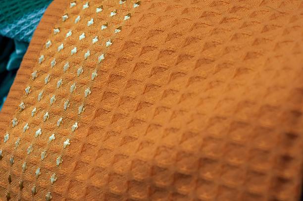 istock An eye-level close-up presents a textured orange waffle weave fabric with detailed structure. 2234825683