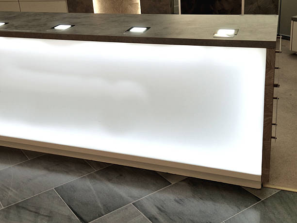 istock counter with white front lighting and square recessed lights on the table top. Used to present products and illuminate the company logo, tile, tiled floorn gray brown 2234826272