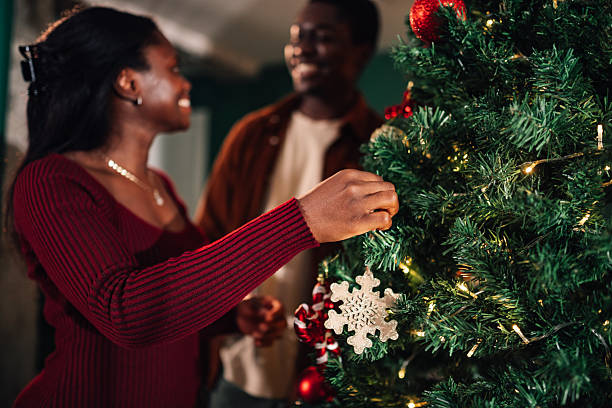 istock Young couple decorating christmas tree at home 2234829270