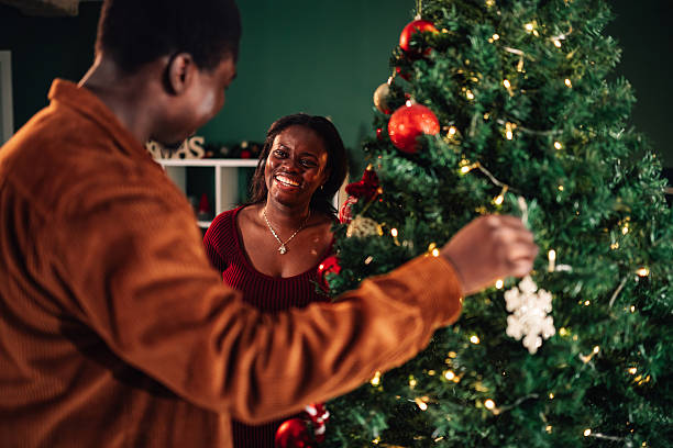 istock Couple decorating christmas tree at home together 2234829292
