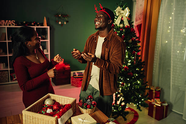 istock Couple decorating christmas tree and having fun at home 2234829328